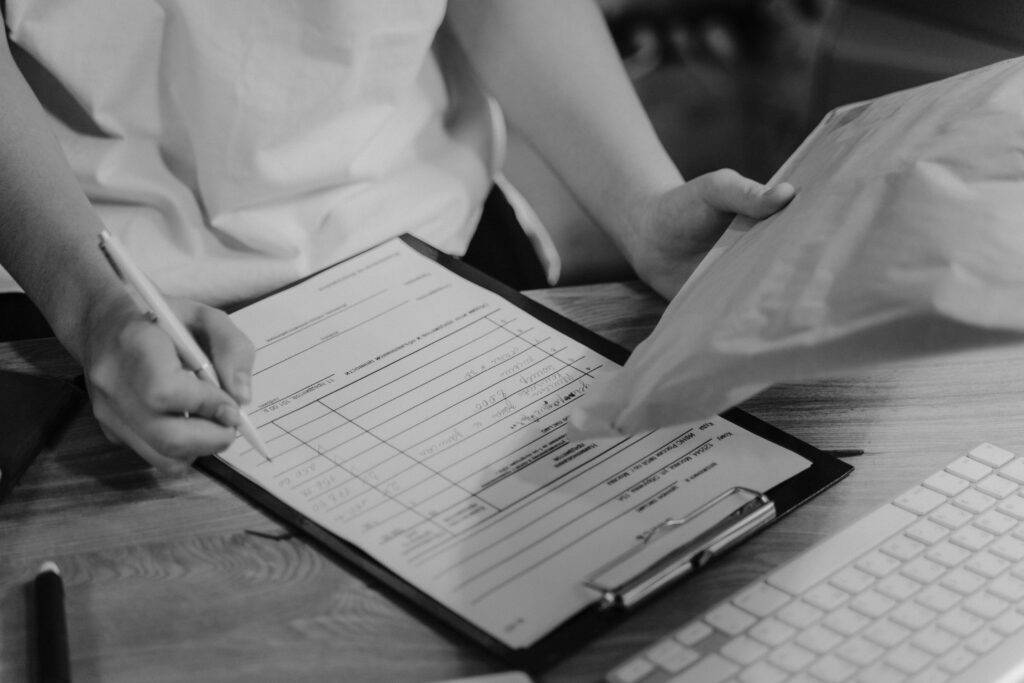a person writing a list on a paper by hand